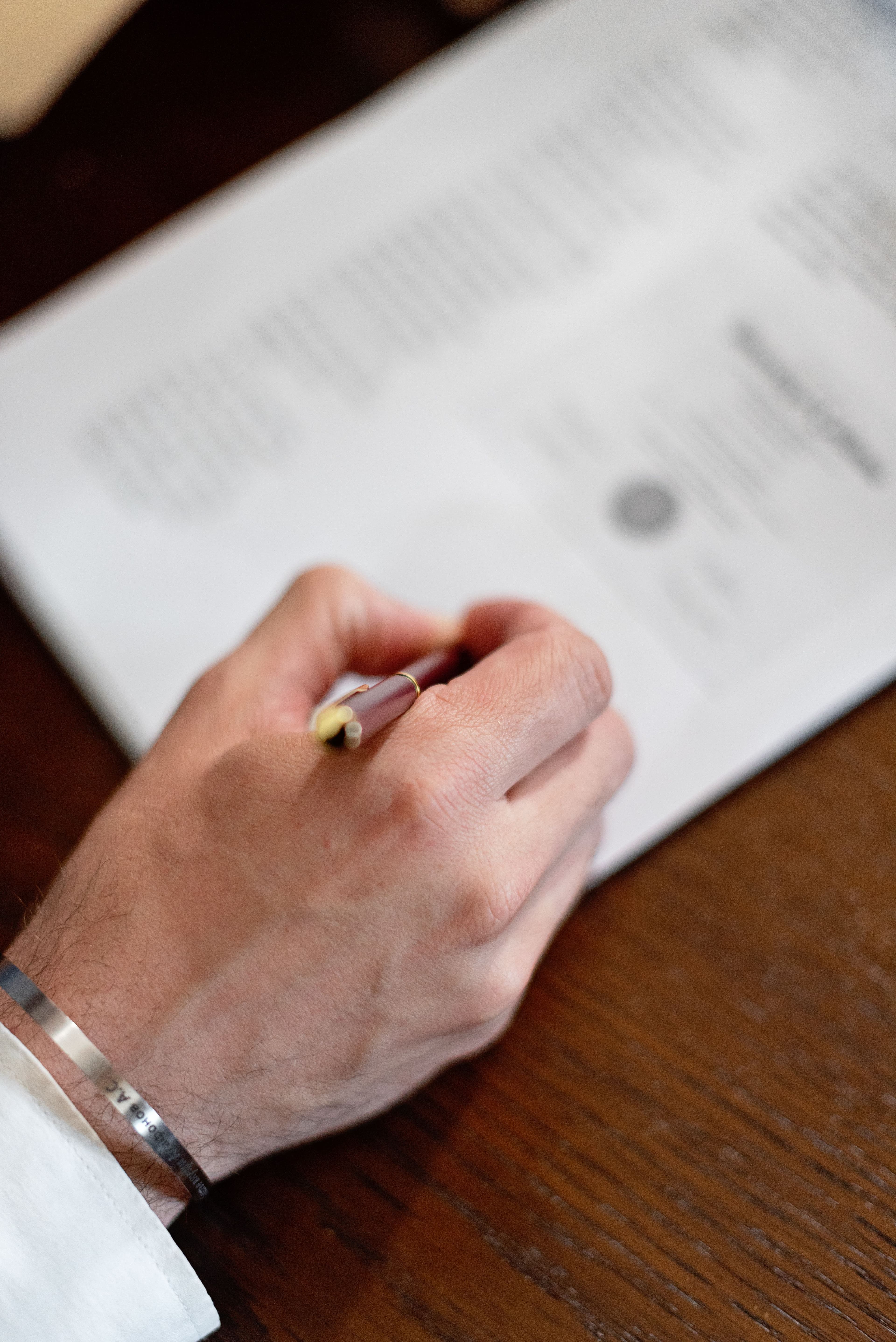 A hand reviewing and approving a printed document